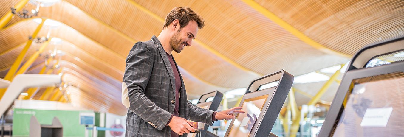 man in airport on checking machine 